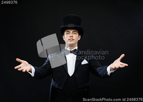 Image of magician in top hat showing trick