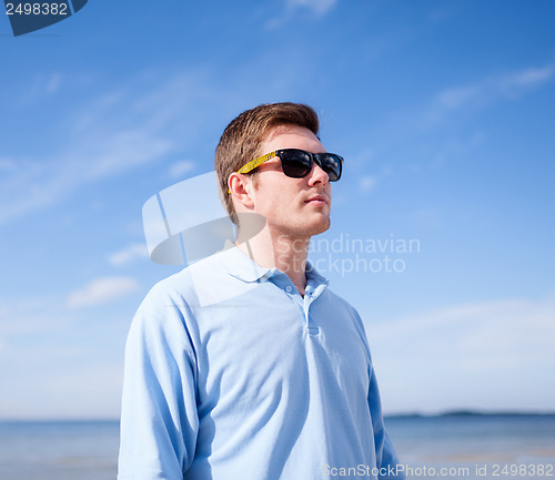 Image of man in sunglasses on the beach