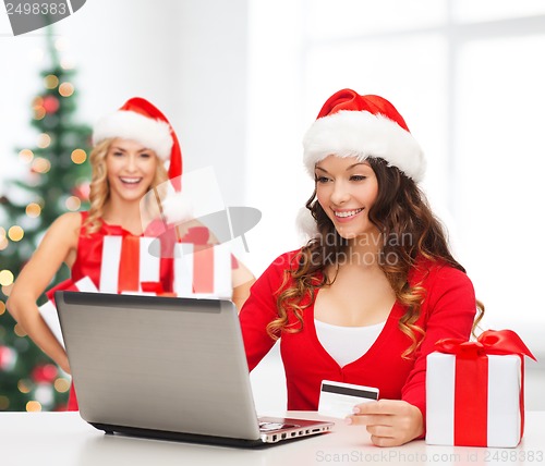 Image of women with gift, laptop computer and credit card