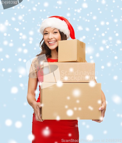 Image of smiling woman in santa helper hat with parcels