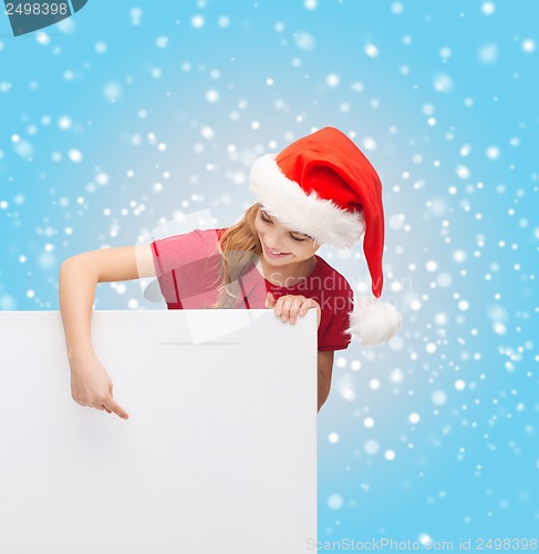 Image of woman in santa helper hat with blank white board