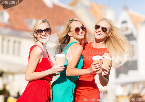 Image of women with takeaway coffee cups in the city