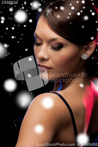 Image of woman in evening dress wearing diamond earrings