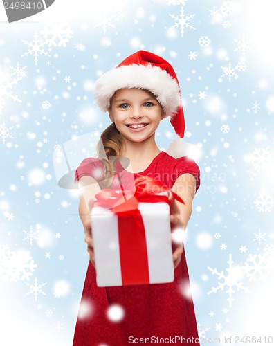 Image of smiling girl in santa helper hat with gift box