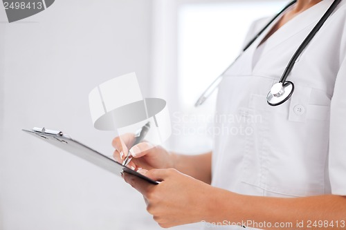 Image of female doctor with stethoscope and prescription