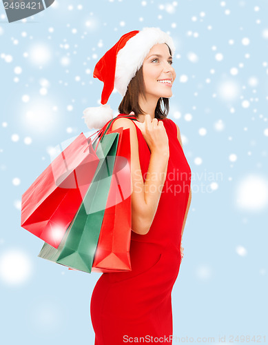 Image of woman in red dress with shopping bags