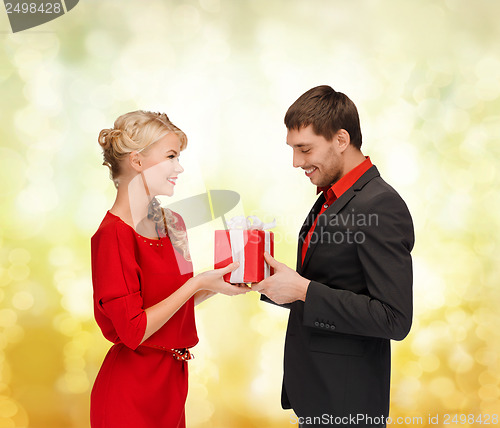 Image of smiling woman and man with gift box
