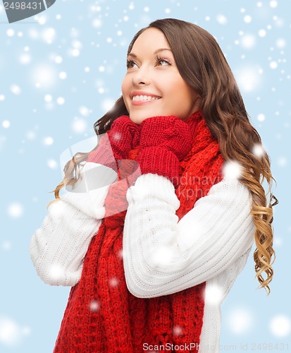 Image of woman in sweater, scarf and mittens