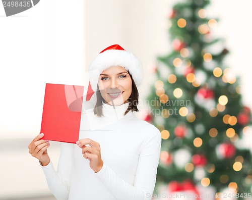 Image of woman in santa helper hat with blank red card