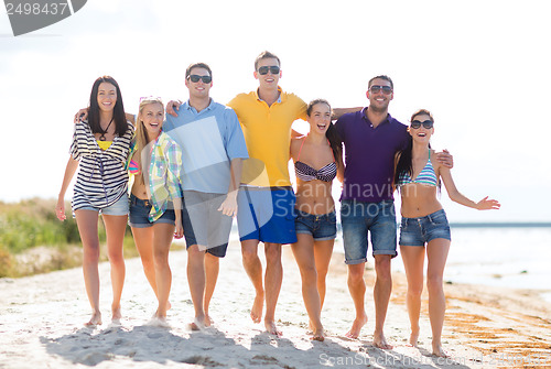 Image of group of friends having fun on the beach