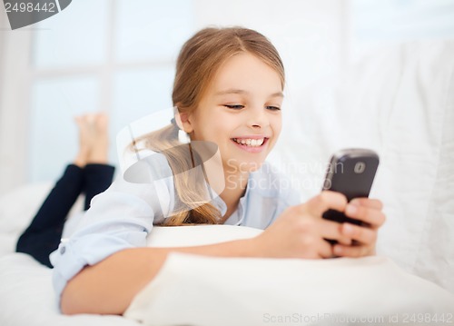 Image of girl with smartphone at home