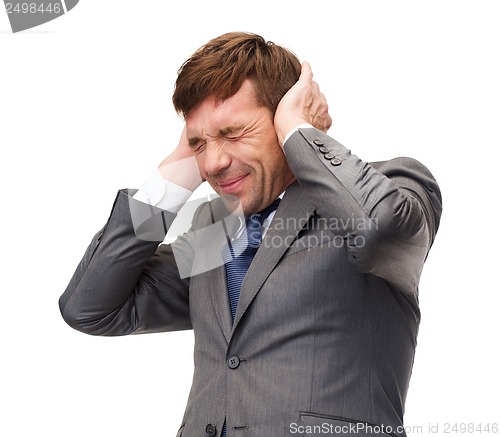 Image of stressed buisnessman or teacher closing ears