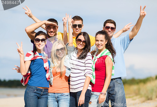 Image of group of friends having fun on the beach