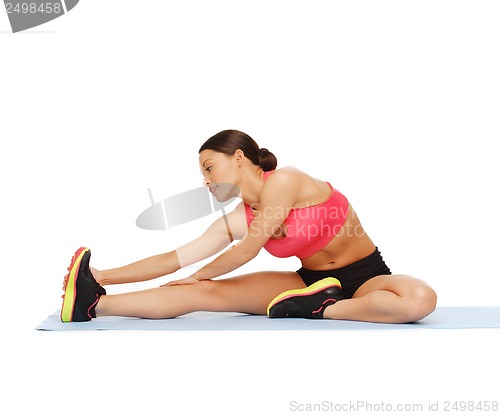 Image of sporty woman doing exercise on the floor