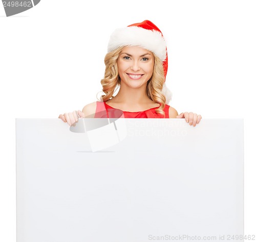 Image of woman in santa helper hat with blank white board