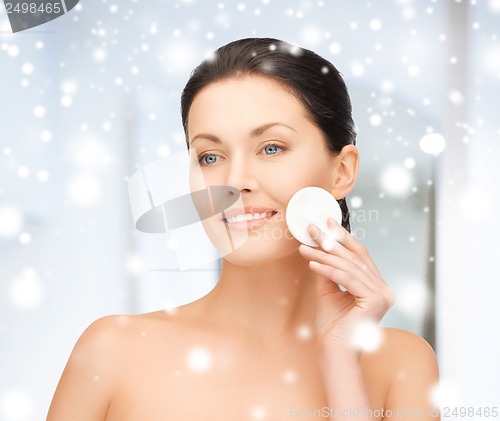 Image of beautiful woman with cotton pad