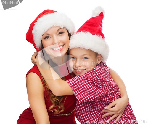 Image of happy mother and child boy in santa helper hats