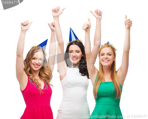 Image of three women wearing hats and showing thumbs up
