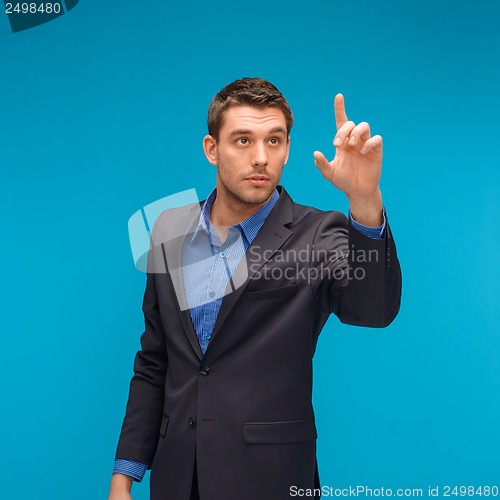 Image of businessman working with imaginary virtual screen