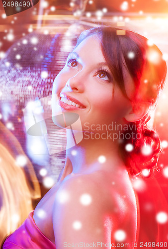 Image of woman in evening dress wearing diamond earrings