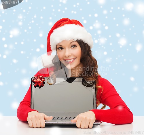 Image of woman in santa helper hat with laptop computer