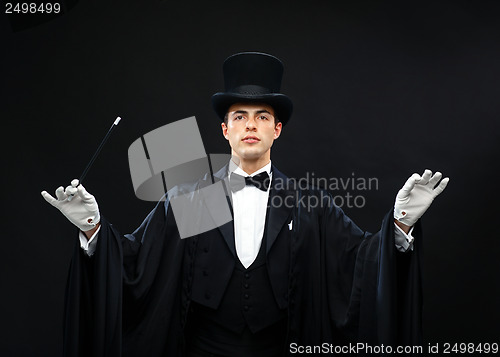 Image of magician in top hat with magic wand showing trick