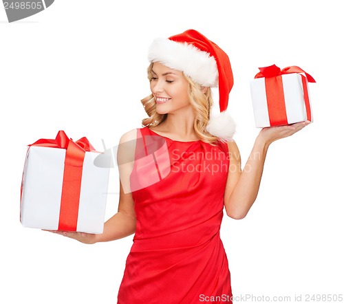 Image of woman in santa helper hat with many gift boxes