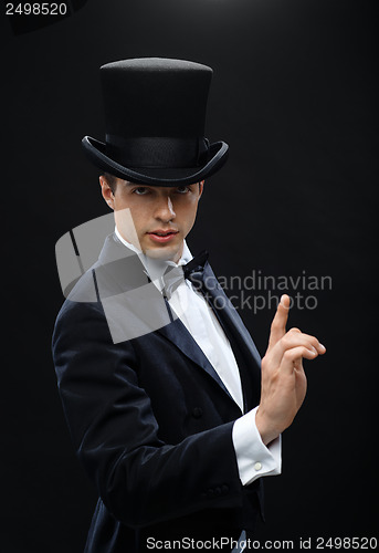 Image of magician in top hat showing trick