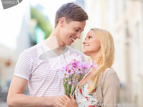 Image of couple with flowers in the city