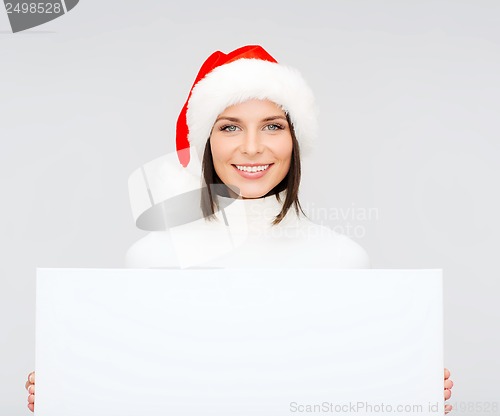 Image of woman in santa helper hat with blank white board