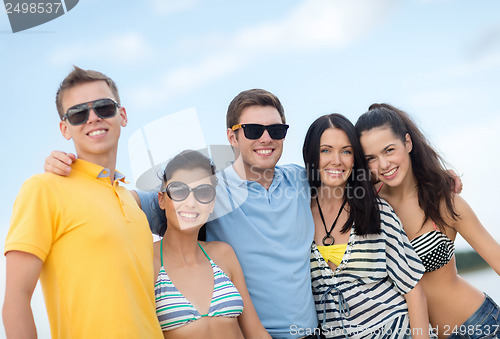 Image of group of friends having fun on the beach