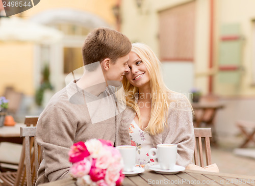 Image of romantic happy couple kissing in the cafe