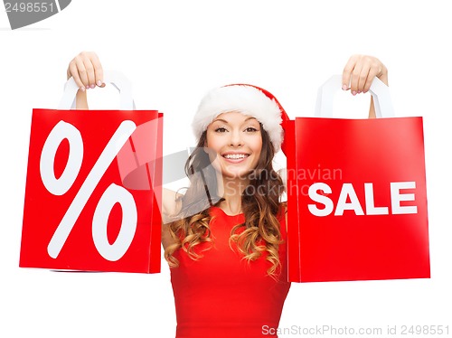 Image of woman in red dress with shopping bags