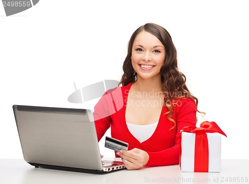 Image of woman with gift, laptop computer and credit card