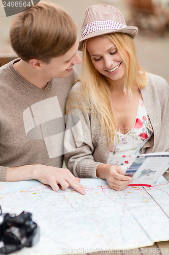 Image of couple with map, camera and travellers guide