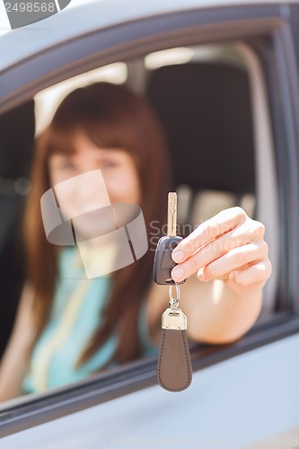 Image of happy woman holding car key