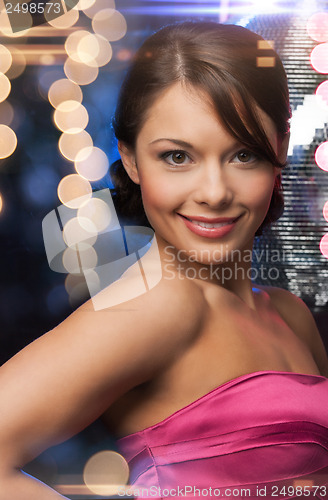 Image of woman in evening dress wearing diamond earrings