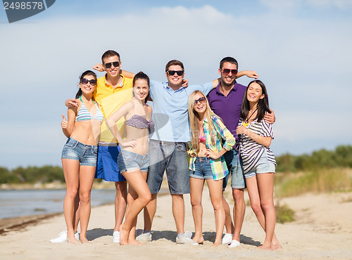 Image of group of friends having fun on the beach