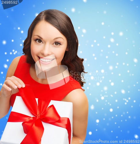 Image of smiling woman in red dress with gift box