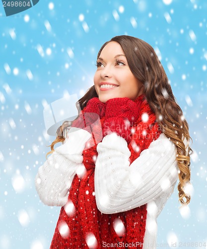 Image of woman in sweater, scarf and mittens