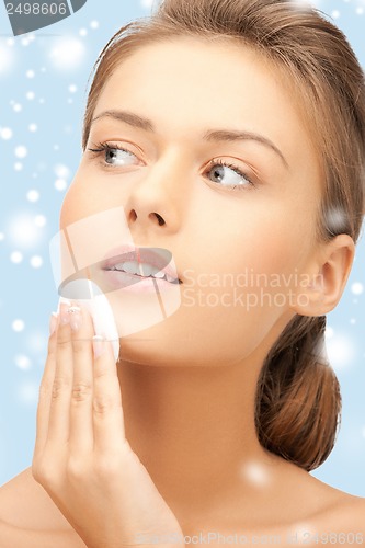 Image of beautiful woman with cotton pad