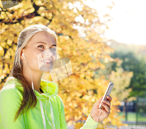Image of woman listening to music outdoors