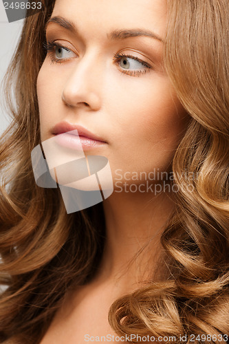 Image of beautiful calm woman with long curly hair