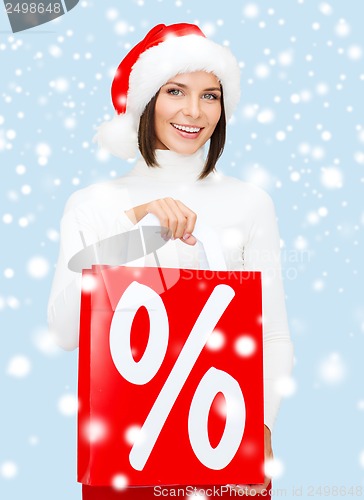 Image of woman in santa helper hat with shopping bags