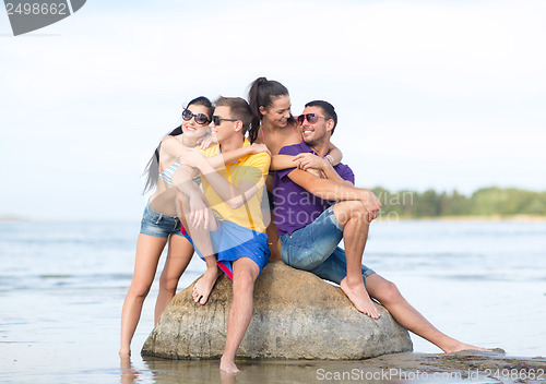 Image of group of friends having fun on the beach