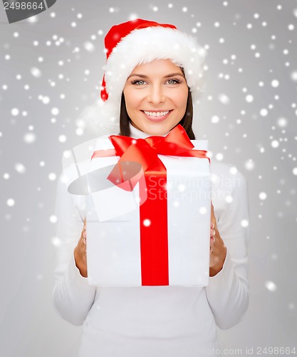 Image of smiling woman in santa helper hat with gift box