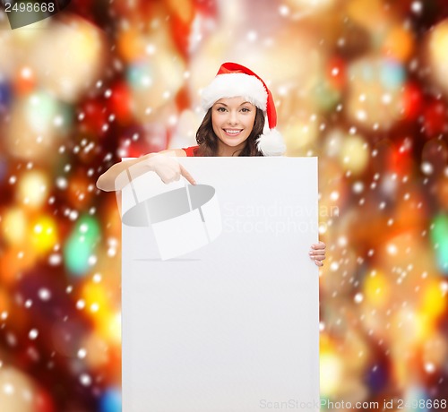 Image of woman in santa helper hat with blank white board