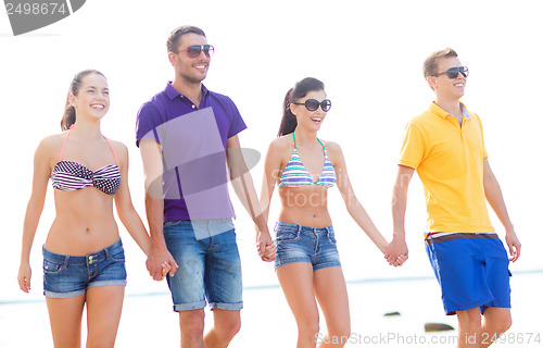 Image of group of friends having fun on the beach