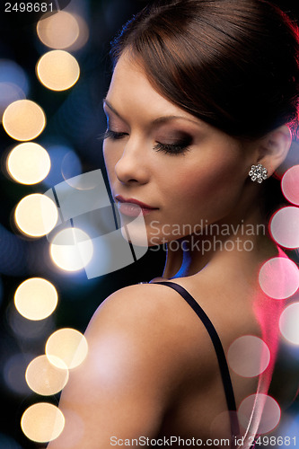 Image of woman in evening dress wearing diamond earrings