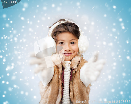 Image of happy littl girl in winter clothes